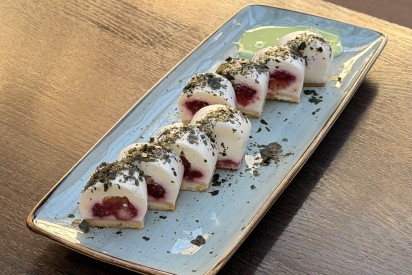 Cheesecake roll with apple-yuzu and raspberries